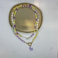 Kralenketting ( paars / geel / wit) met hondje
