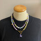 Kralenketting ( paars / geel / wit) met hondje