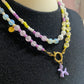 Kralenketting ( paars / geel / wit) met hondje